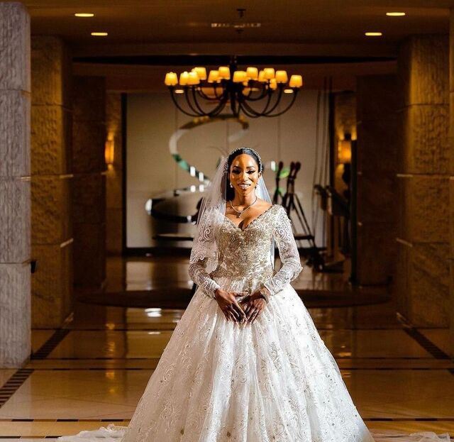 Bride in a couture lace ball gown with cathedral train